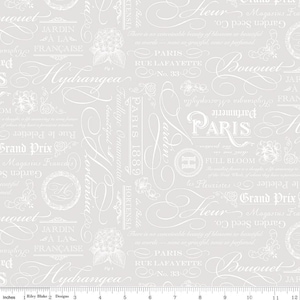 May include: A light gray fabric with a repeating pattern of white floral illustrations and French script. The design includes words like "Hydrangea," "Paris," and "Bouquet," creating a vintage, romantic aesthetic. The fabric is suitable for various craft projects.