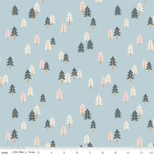 May include: A light blue fabric with a repeating pattern of white, pink, and blue stylized pine trees. The fabric is marked with a ruler in inches.
