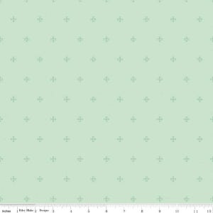 May include: A light green fabric with a repeating pattern of small, dark green crosses. The fabric is textured and has a subtle sheen.