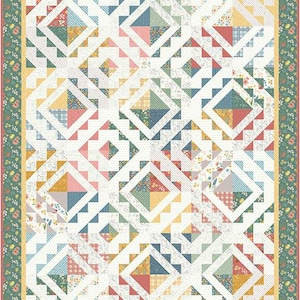 May include: A quilt with a white background and a geometric pattern of squares and triangles in various colors, including blue, green, yellow, pink, and red. The quilt is framed with a green border with floral accents.