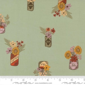 May include: A light green fabric featuring a repeating pattern of illustrated canisters labeled coffee or tea, each filled with bouquets of sunflowers, red flowers, and purple blossoms. A white ruler is visible at the bottom edge of the image.