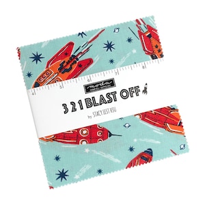 May include: A stack of fabric squares with a space theme. The fabric features red and orange rockets, blue stars, and planets on a light blue background. The text "3 21 BLAST OFF" is printed on a white band.