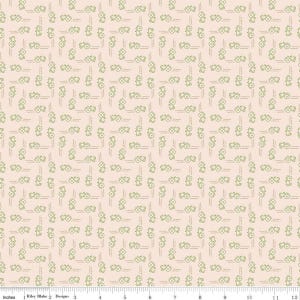 May include: A fabric with a repeating pattern of green tractor illustrations and vertical dashed lines on a light peach background. The fabric is marked with inch measurements along the bottom edge.