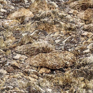 May include: A close-up view of a collection of various-sized rocks and stones. The rocks are primarily shades of brown, tan, and gray, with rough textures and irregular shapes. The image suggests a natural, outdoor setting.