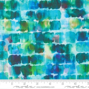 May include: A fabric swatch featuring a repeating grid of watercolor-style squares in shades of teal, turquoise, blue, and green. The pattern includes soft, blended edges and varying color intensities, with a white ruler visible at the bottom.