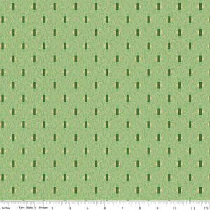 May include: Green fabric with a repeating pattern of dark green rectangles and light beige half-circles on a light green background. The fabric is marked with inches along the bottom edge.