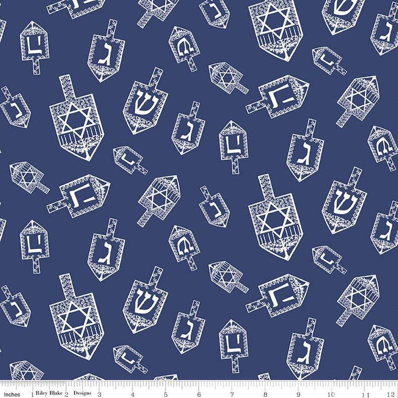 May include: Navy blue fabric with a repeating pattern of white dreidels. The dreidels feature Hebrew letters and Star of David designs, creating a festive and celebratory theme. The fabric is suitable for various craft projects.