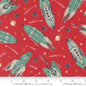 May include: Red fabric with a repeating pattern of retro-style rockets, planets, stars, and comet trails. The rockets are green, cream, and blue. The planets are orange and white. The stars are white and navy. The fabric has a space or science fiction theme.