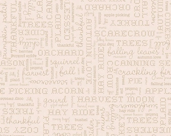 May include: A beige fabric with a repeating pattern of brown text. The text includes words related to autumn, such as "pumpkin", "harvest", "fall", "leaves", "trees", "hay ride", and "canning season".