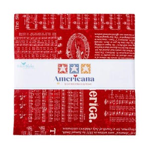 May include: A stack of red fabric squares with white musical notes and text. The squares are bound with a white band that reads "Americana" and features star designs. The fabric is from Riley Blake Designs.