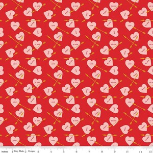 May include: A red background with a repeating pattern of pink hearts, gold arrows, and text. The hearts have phrases like "Be Mine," "Sweet," and "Love." The arrows are piercing the hearts, creating a romantic theme.