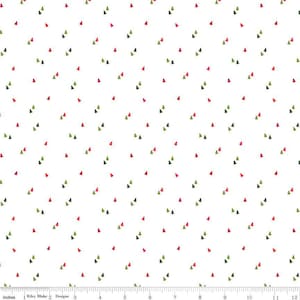 May include: White fabric with a repeating pattern of small green and red Christmas trees. The fabric is marked with inches from 1 to 12.
