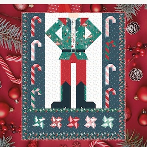 May include: A quilt pattern titled BE A NUTCRACKER featuring a central nutcracker figure in green, red, and black on a white background, surrounded by a dark blue border with candy cane motifs. The finished size is 60 1/2 inches by 72 1/2 inches.