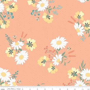 May include: A peach-colored fabric with a repeating pattern of white daisies, yellow flowers, green leaves, and small bees. The fabric has a subtle speckled texture.