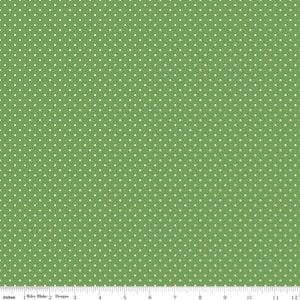 May include: A green fabric with a white polka dot pattern. The fabric is a solid green color with small white dots evenly spaced throughout.