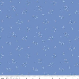 May include: A blue fabric with a white and light blue pattern of circles. The circles are arranged in a random pattern and are of varying sizes.