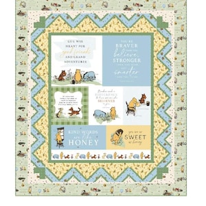 May include: A patchwork quilt with a green border and a central design featuring Winnie the Pooh characters and inspirational quotes. The quilt has a light blue and yellow color scheme, with text that reads "Wrapped in Love."