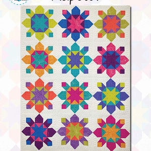 May include: A colorful quilt pattern featuring a grid of starburst designs in various colors, including teal, pink, orange, and purple. The word "Kapow!" is written in black script. The pattern is available in Baby, Throw, Full, Twin, Queen, and King sizes.