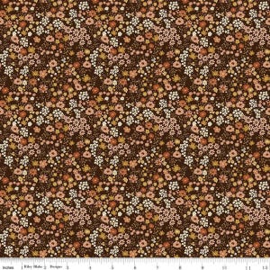 May include: A dark brown fabric featuring a dense, repeating pattern of small wildflowers in shades of cream, light pink, mustard yellow, and burnt orange. A white ruler at the bottom indicates a scale of 12 inches for the fabric design.