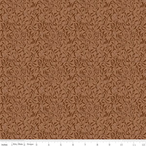 May include: Brown fabric with a repeating pattern of stylized leaves and vines. The design features a light brown background with darker brown leaf and vine details. The fabric is measured in inches.
