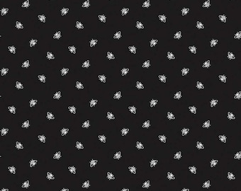 May include: Black fabric with a white repeating pattern of bees. The fabric is a quilting cotton and is perfect for crafting projects.