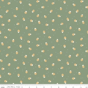 May include: Green fabric with a repeating pattern of small, tan mushrooms with white polka dots. Tiny white dots are scattered across the background. The fabric is measured in inches.