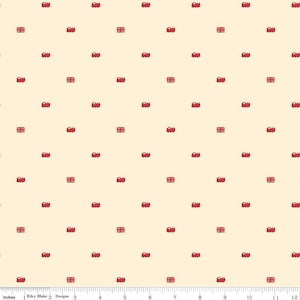 May include: Cream-colored fabric with a repeating pattern of red double-decker buses and Union Jack flags. The buses and flags are evenly spaced across the fabric, creating a uniform design.