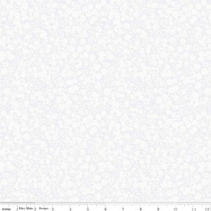 May include: White fabric with a delicate floral pattern. The design features small, light-colored flowers and leaves scattered across a white background. The fabric is measured in inches.