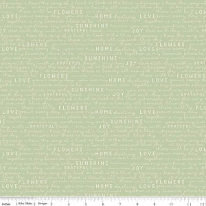May include: A green fabric with white text that repeats the phrases "Love grows every day", "You are my home darling", "Sunshine", "Joy", "Flowers", and "Together is my favorite place to be".