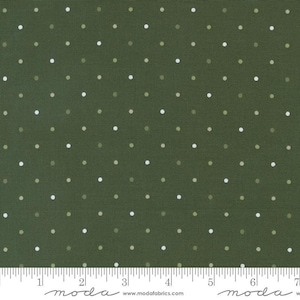 May include: Dark green fabric with a repeating pattern of small, evenly spaced white and light green polka dots. The fabric has a textured appearance and a ruler is at the bottom. The website address www.modafabrics.com is printed at the bottom.