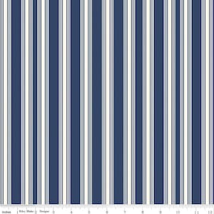 May include: A navy blue and white striped fabric with a repeating pattern. The fabric is shown on a ruler with inches marked.