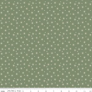 May include: Sage green fabric with a repeating pattern of white starbursts and small white dots. The fabric is measured in inches along the bottom edge, with the text "Riley Blake Designs" visible.