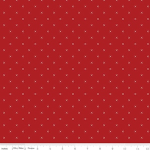 May include: Red fabric with a white x pattern repeated throughout the fabric.
