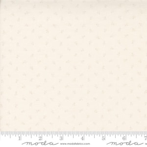 May include: A white fabric with a subtle, light pink floral pattern. The fabric is a solid white with a small, delicate floral print. The fabric is shown with a ruler for scale.