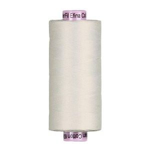 May include: A spool of off-white sewing thread. The thread is tightly wound around a cylindrical core. The top and bottom of the spool are a light purple color with white text. The brand name "Efilna Col" is visible on the top of the spool.