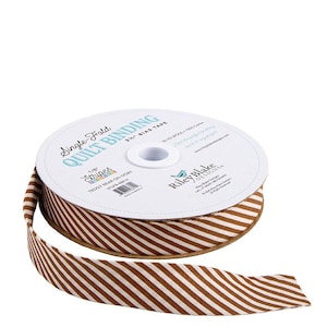 May include: A spool of brown and ivory striped quilt binding tape. The tape is labeled "Single Fold Quilt Binding" and "Teddy Bear on Ivory". The tape is 2.5 inches wide and made of 100% cotton.