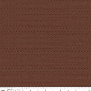 May include: A brown fabric with a repeating pattern of small, dark brown dots. The fabric has a subtle texture and a slightly distressed look.