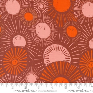 May include: A brown fabric with a repeating pattern of pink and orange sunburst shapes. The fabric has a subtle texture and a vintage feel.