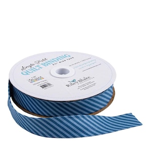 May include: A spool of blue and light blue striped quilt binding tape. The tape is labeled "Single Fold Quilt Binding" and "Stripes Denim Tonal". The spool is made by Riley Blake Designs.