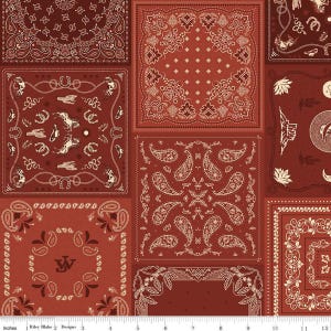 May include: A patchwork fabric featuring various bandana designs in shades of red and cream. The patterns include paisley, floral, and Western-themed motifs like horseshoes and cowboy hats. The fabric is approximately 12 inches wide.