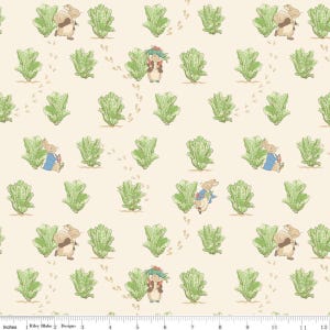 May include: A repeating pattern featuring illustrations of rabbits in blue jackets and brown coats, along with green lettuce and footprints on a cream background. The design includes the text "Riley Blake Designs".