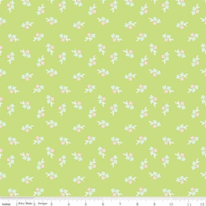 May include: Lime green fabric with a repeating pattern of small floral clusters in pink, light blue, and white. The flowers are evenly spaced across the fabric. The fabric is measured in inches.