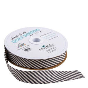 May include: A spool of single-fold quilt binding tape with a charcoal and ivory striped pattern. The label reads "Single-Fold Quilt Binding" and "Stripes Charcoal on Ivory". The tape is 2.25" wide.