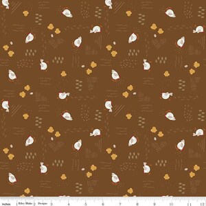 May include: A brown fabric with a repeating pattern of white birds and abstract shapes in shades of brown and yellow.