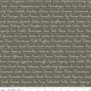 May include: A brown fabric with white text listing various words in alphabetical order. The words are written in a cursive font. The fabric is 12 inches wide and has a ruler marked in inches along the bottom.