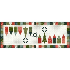 May include: A green and red patchwork table runner with a white background featuring a Christmas theme. The runner has a border of green, red, and white squares. The center of the runner features a row of green and red houses, a green Christmas tree, and a row of green and red stars.
