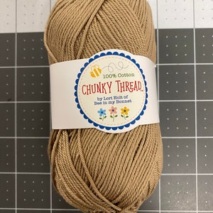 May include: A skein of brown 100% cotton yarn labeled "CHUNKY THREAD by Lori Holt of Bee in my Bonnet."