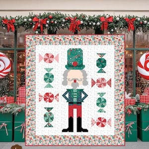 May include: A quilt pattern titled Nutcracker Sweet by Sew A Story featuring a central nutcracker figure surrounded by candy motifs on a white background with a multi-colored border. The finished size is 60 1/2 inches by 67 1/2 inches.