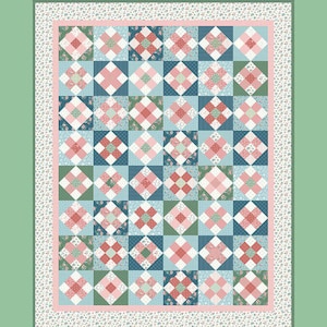 May include: A patchwork quilt with a floral and geometric pattern in shades of pink, blue, and green. The quilt features a repeating block design with a floral border and the text "A Stitch in Time". The top right corner has the text "Amy Smart Diary of a Quilter".