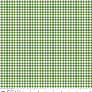 May include: A green and white gingham fabric pattern featuring a repeating checkered design. A ruler is visible at the bottom edge, showing measurements in inches from 1 to 12. The text Riley Blake Designs is printed on the ruler.